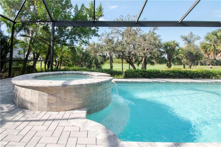 Enjoy the private golf/lake view through your picture window screened lanai