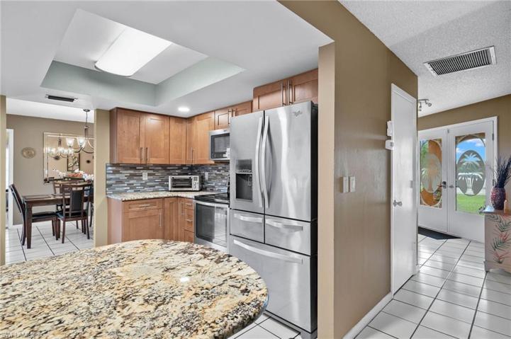 Kitchen has breakfast bar with pantry around the side