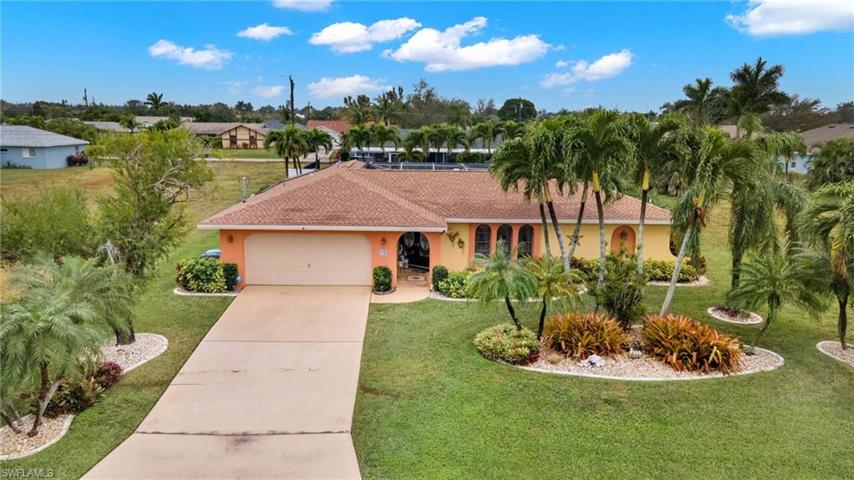 Front Elevation with lots of tropical landscaping