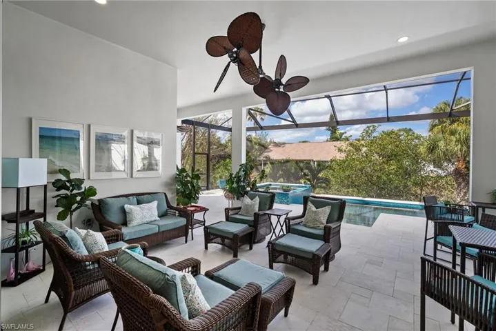 Sunroom featuring a swimming pool and ceiling fan