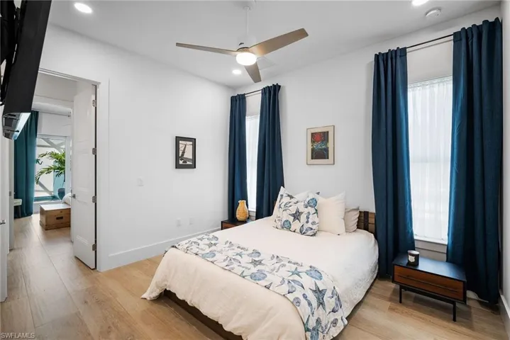 Bedroom with light hardwood / wood-style floors and ceiling fan