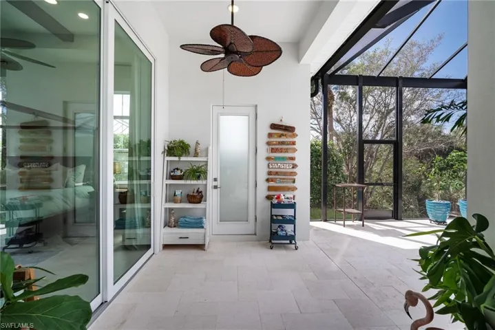 Unfurnished sunroom featuring ceiling fan