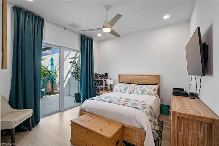 Bedroom featuring access to outside, light wood-type flooring, and ceiling fan