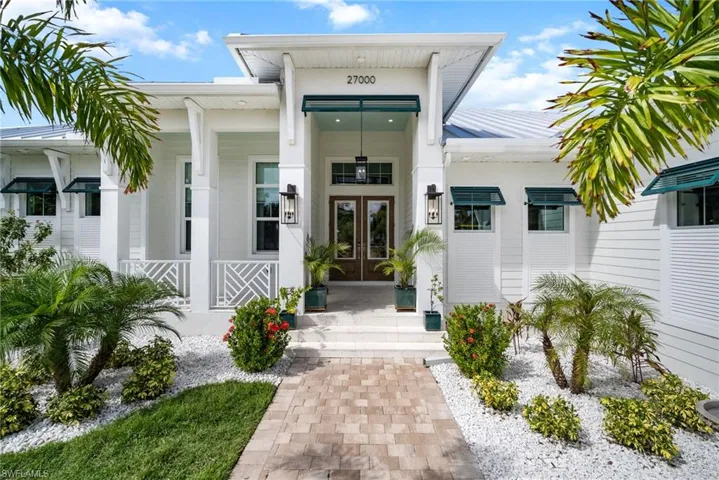 Doorway to property featuring french doors and covered porch