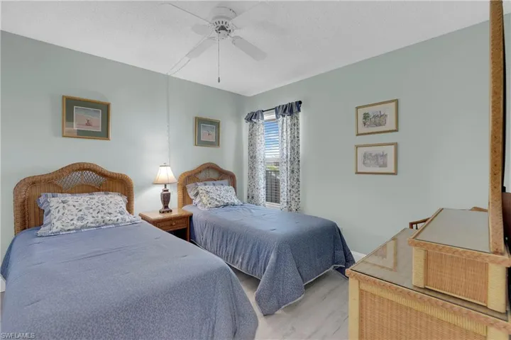 Bedroom featuring wood finished floors, a textured ceiling, and a ceiling fan