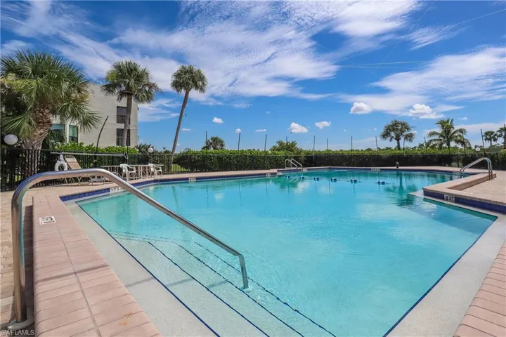 Community pool with a patio