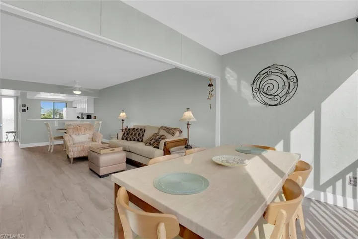 Dining space with light wood-style floors and ceiling fan