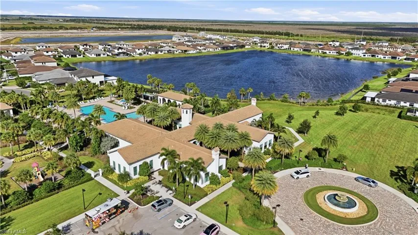 Aerial view of residential area featuring a large body of water and a pool