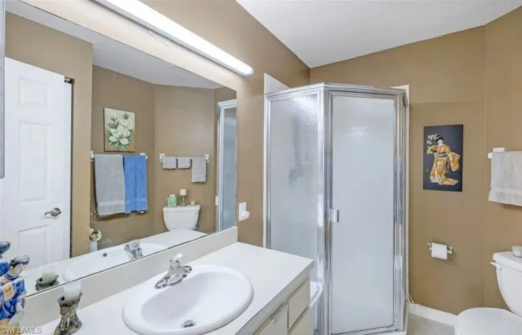 Bathroom with a stall shower and vanity