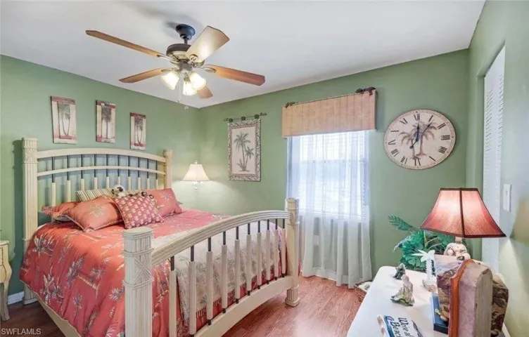Bedroom with wood finished floors and ceiling fan