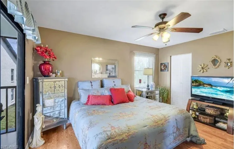 Bedroom with light wood finished floors and a ceiling fan