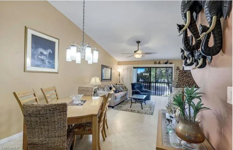 Dining space featuring a ceiling fan, a chandelier, and light tile patterned floors