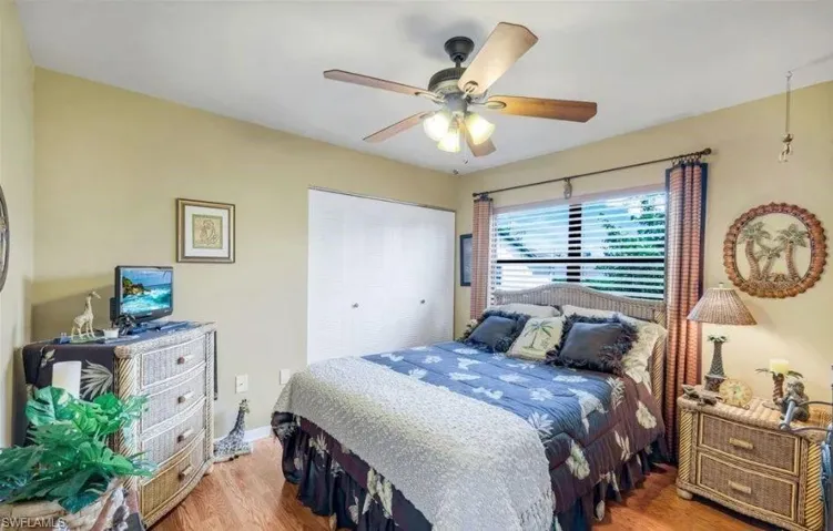 Bedroom featuring wood finished floors, a closet, and ceiling fan