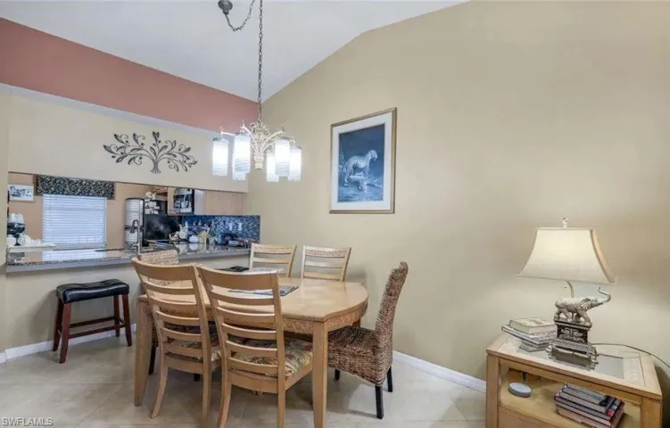 Dining space with lofted ceiling and hanging lights
