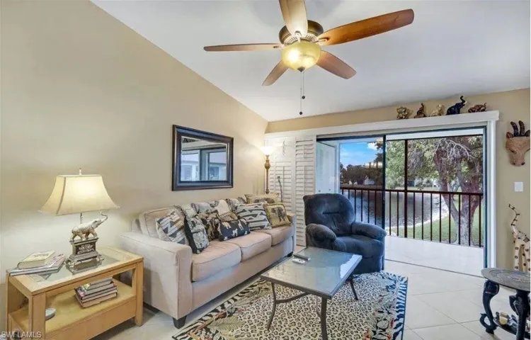 Living area with ceiling fan, lofted ceiling, and light tile patterned floors