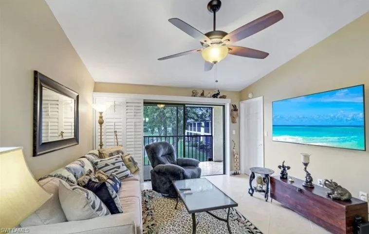 Living room featuring lofted ceiling and ceiling fan