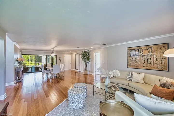 Living area featuring ornamental molding and wood finished floors