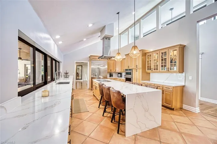 Living area with wood finished floors, recessed lighting, a fireplace, and ornamental molding
