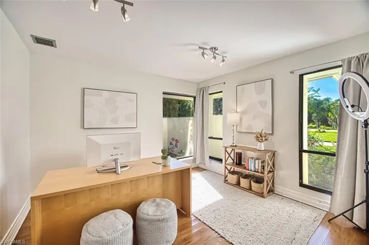 Office with wood finished floors and baseboards