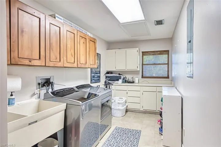 Laundry room featuring washer and dryer and cabinet space