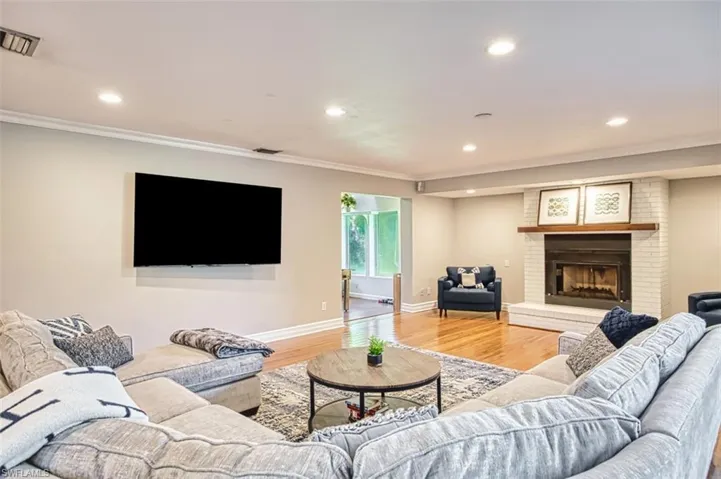 Dining space with light wood finished floors and crown molding