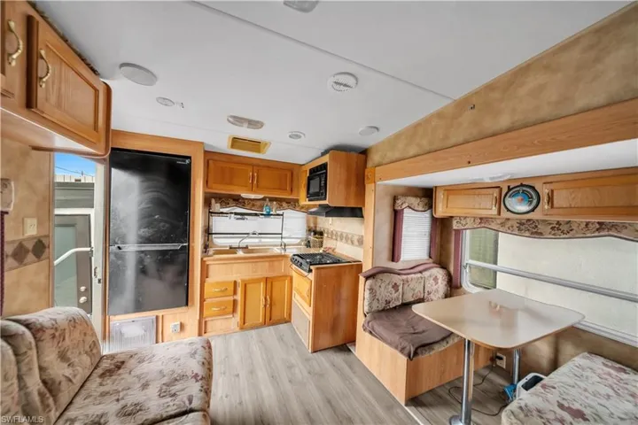 Interior featuring wood-finish flooring and light-toned cabinetry