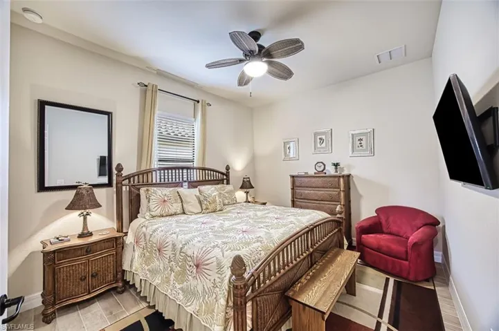 Bedroom with visible vents, ceiling fan, light wood-style tile floors