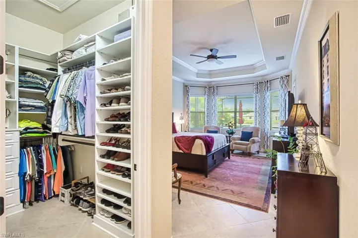 Spacious closet featuring tile patterned flooring & raised ceiling
