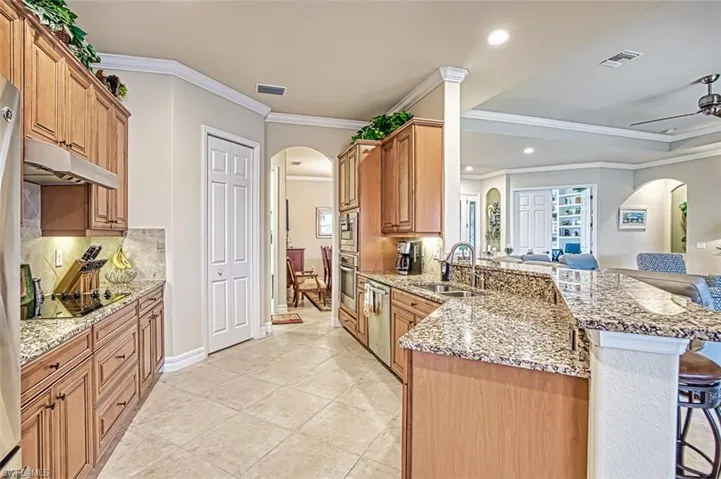 Kitchen with a breakfast bar, stainless appliances and a peninsula