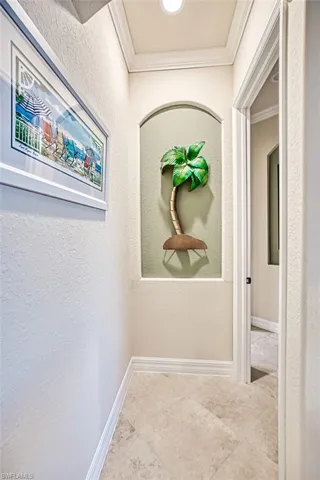 Corridor with a textured wall and ornamental molding
