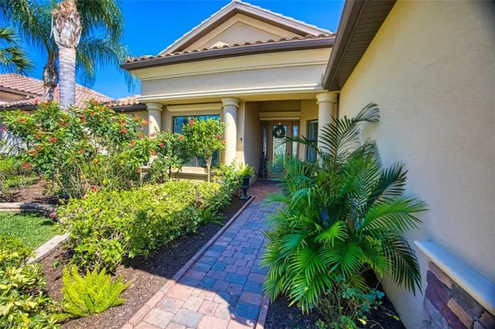 Doorway to property featuring stucco siding and a tiled roof
