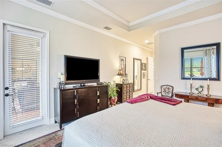 Bedroom featuring crown molding, access to outside, and visible vents