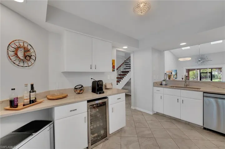 The buffet area of the kitchen features a convenient wine refrigerator, ideally positioned for effortless serving and elegant entertaining.