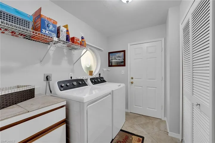 The nicely sized laundry room offers abundant functionality with built-in storage shelving and closet space, creating a well-organized and efficient area for everyday convenience.