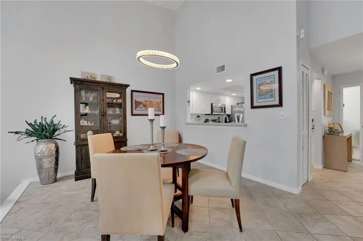 The formal dining space is elegantly defined, with the kitchen wall thoughtfully expanded to enhance effortless serving and maximize spectacular lake views, creating a seamless and refined entertaining experience.
