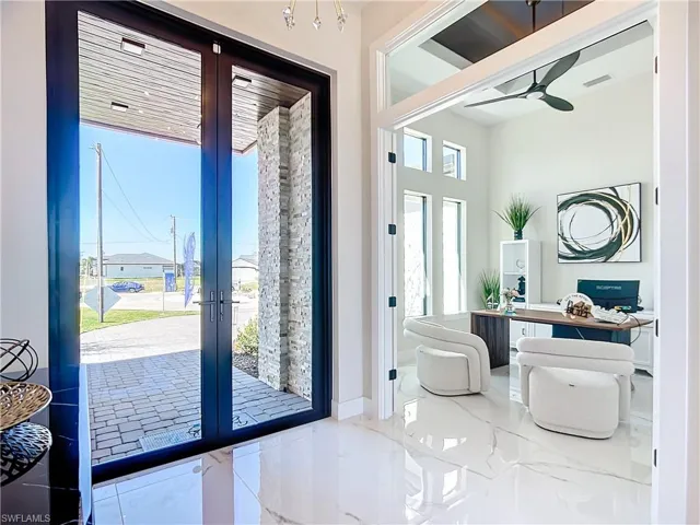 Entryway featuring ceiling fan and french doors