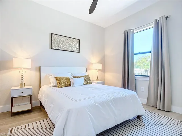 Bedroom featuring light hardwood / wood-style floors and ceiling fan