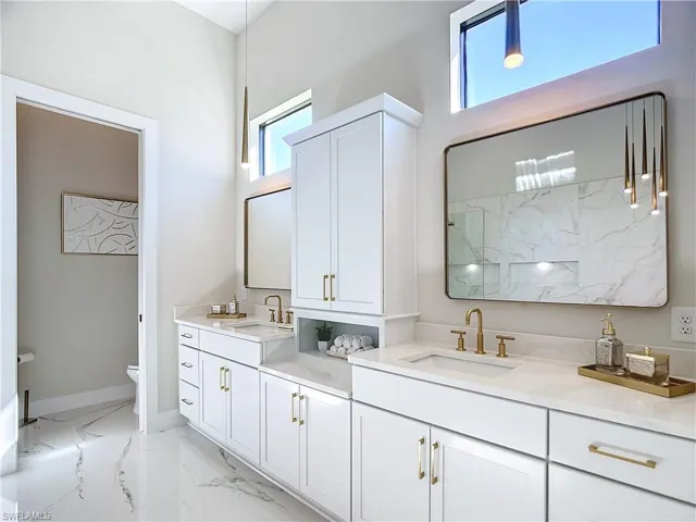 Bathroom with a shower, vanity, and toilet