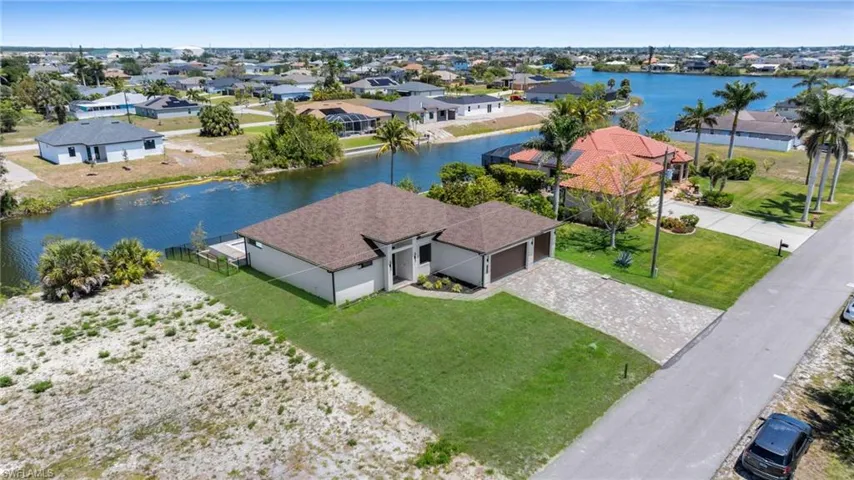 Aerial perspective of suburban area featuring a large body of water