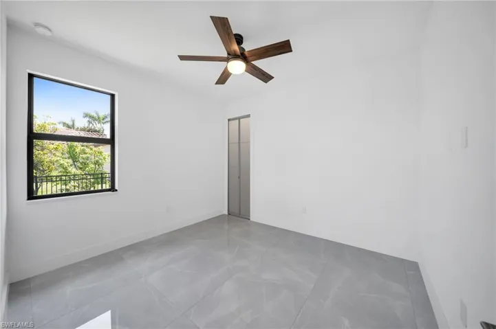 Empty room featuring baseboards and ceiling fan