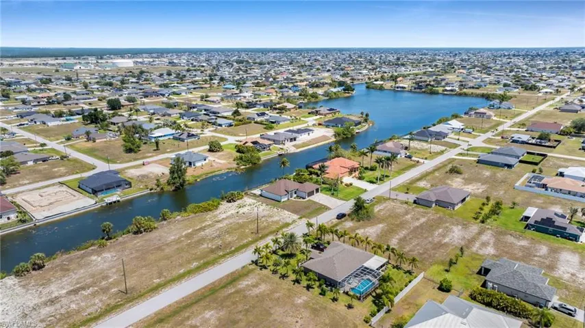 Aerial perspective of suburban area with a nearby body of water