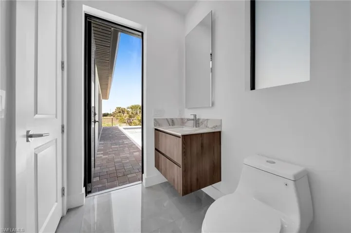Half bathroom featuring vanity and light tile patterned floors