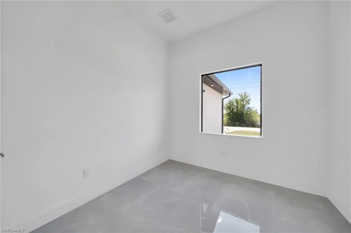 Empty room featuring baseboards