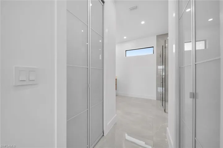 Bathroom featuring recessed lighting, a closet, and a shower with door