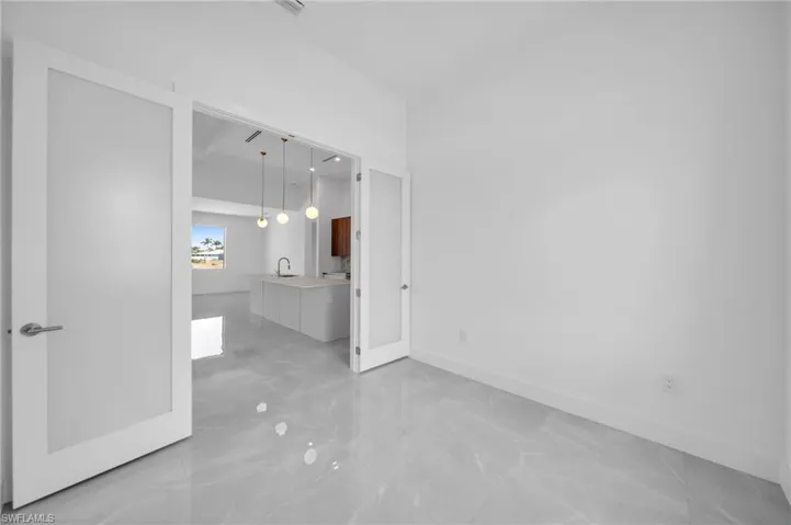 Unfurnished room with baseboards and light marble finish flooring
