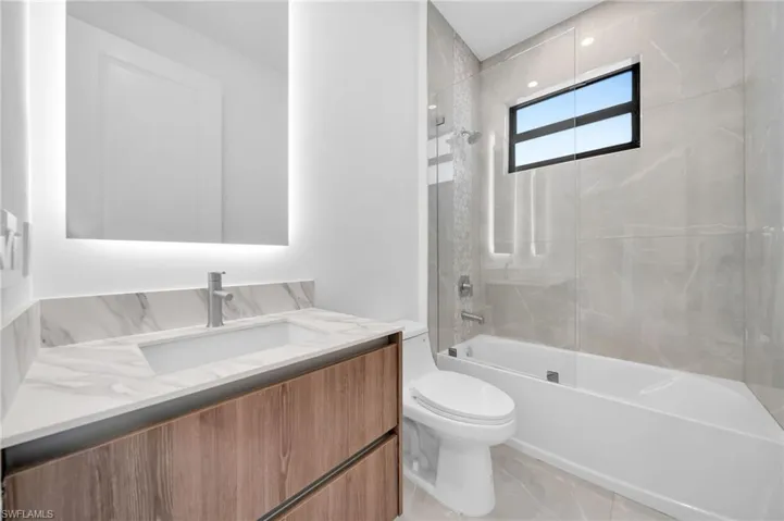Bathroom featuring vanity and bathing tub / shower combination