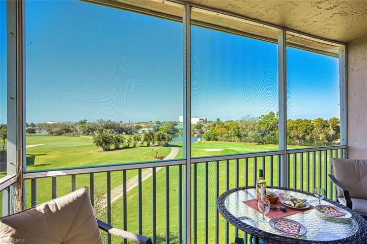 Lanai featuring view of golf course and a water view