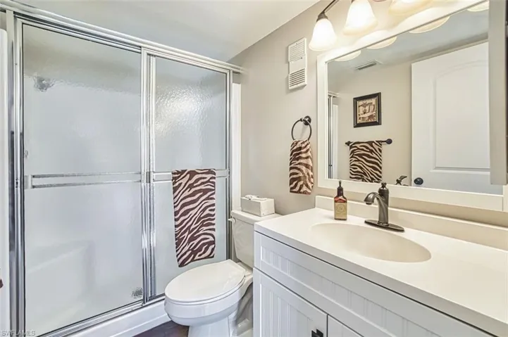 Full bath featuring vanity and a stall shower