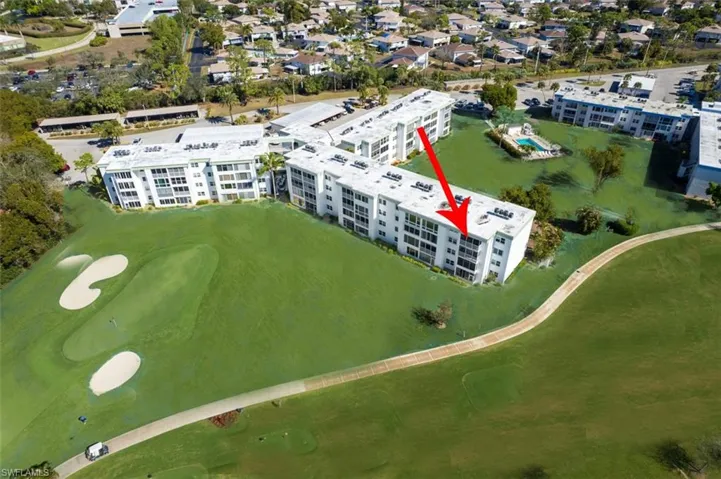 Aerial view of apartment complex / building and a local golf course
