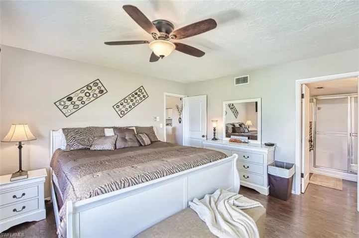 Master Bedroom with dark wood-style floors, a textured ceiling, and ceiling fan